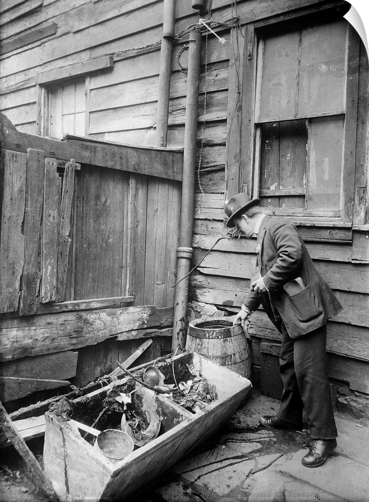 A public health inspector identifying mosquito breeding areas in the backyards of tenement buildings in an effort to preve...