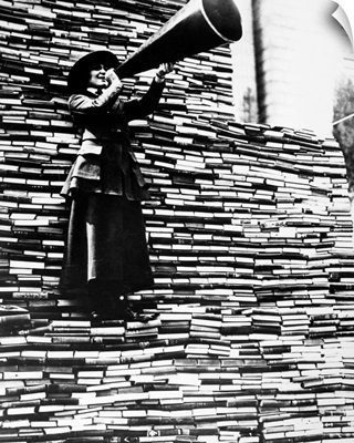 A woman calling for more books during a New York Public Library book drive for  soldiers