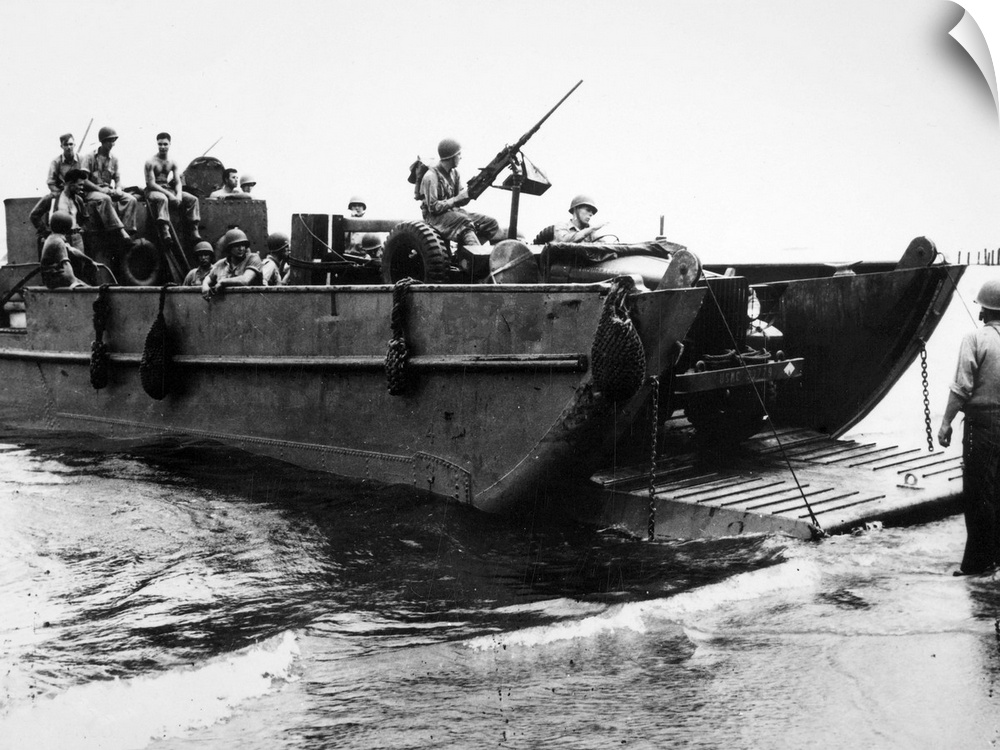 An American landing craft dropping its ramp on the beach at Guadalcanal in the Solomon Islands, as the U.S. Marine reconna...