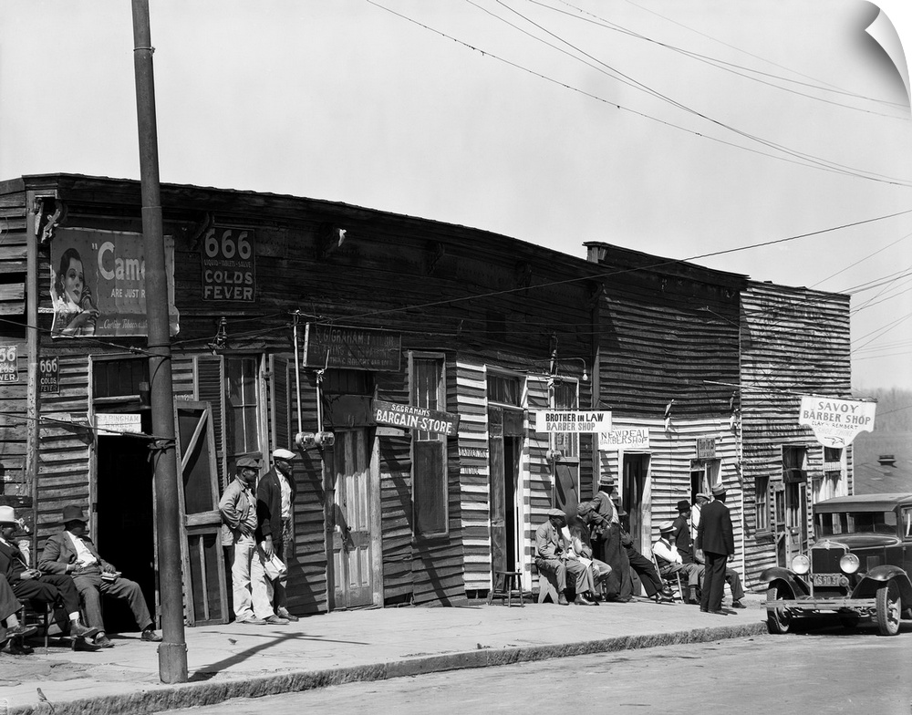A row of African American barbershops in Vicksburg, Mississippi. Photograph, by Walker Evans, 1936.