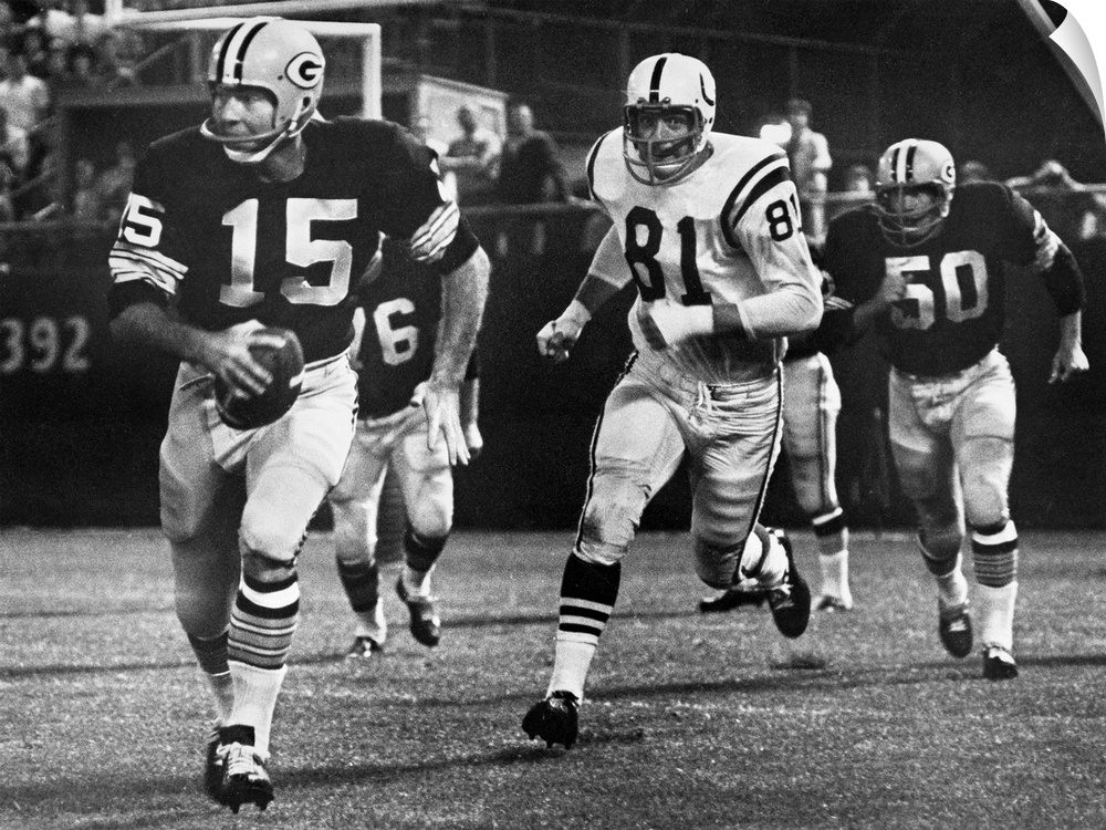 Quarterback Bart Starr of the Green Bay Packers attempting to run for a first down against the Baltimore Colts after faili...