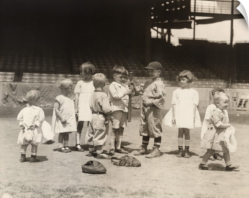 Young boys and girls on a baseball field at a major league stadium. Photograph, early 20th century.