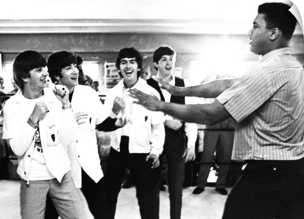 The Beatles (from left: Ringo Starr, John Lennon, George Harrison, and Paul McCartney) clowning with boxer Cassius Clay (l...