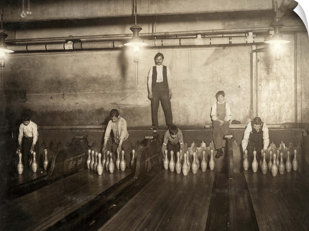 Pin boys working with a supervisor in the Subway Bowling Alleys in Brooklyn, New York. Photograph by Lewis Hine, April 1910.