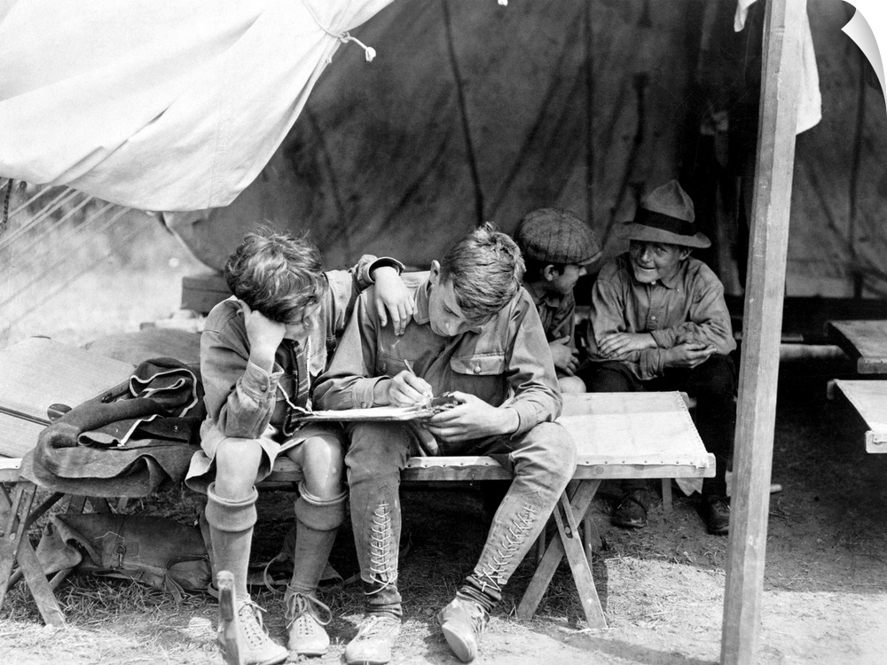 Boy Scouts writing letters home from camp at Hunter Island, in Pelham Bay Park, New York City. Photograph, c1912.