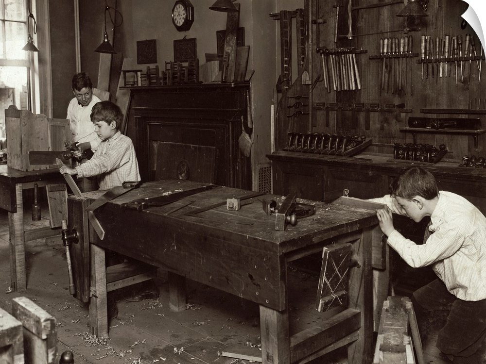 Boys learning carpentry in a woodwork shop class at the Henry St. Settlement in New York City. Photograph by Lewis Hine, M...