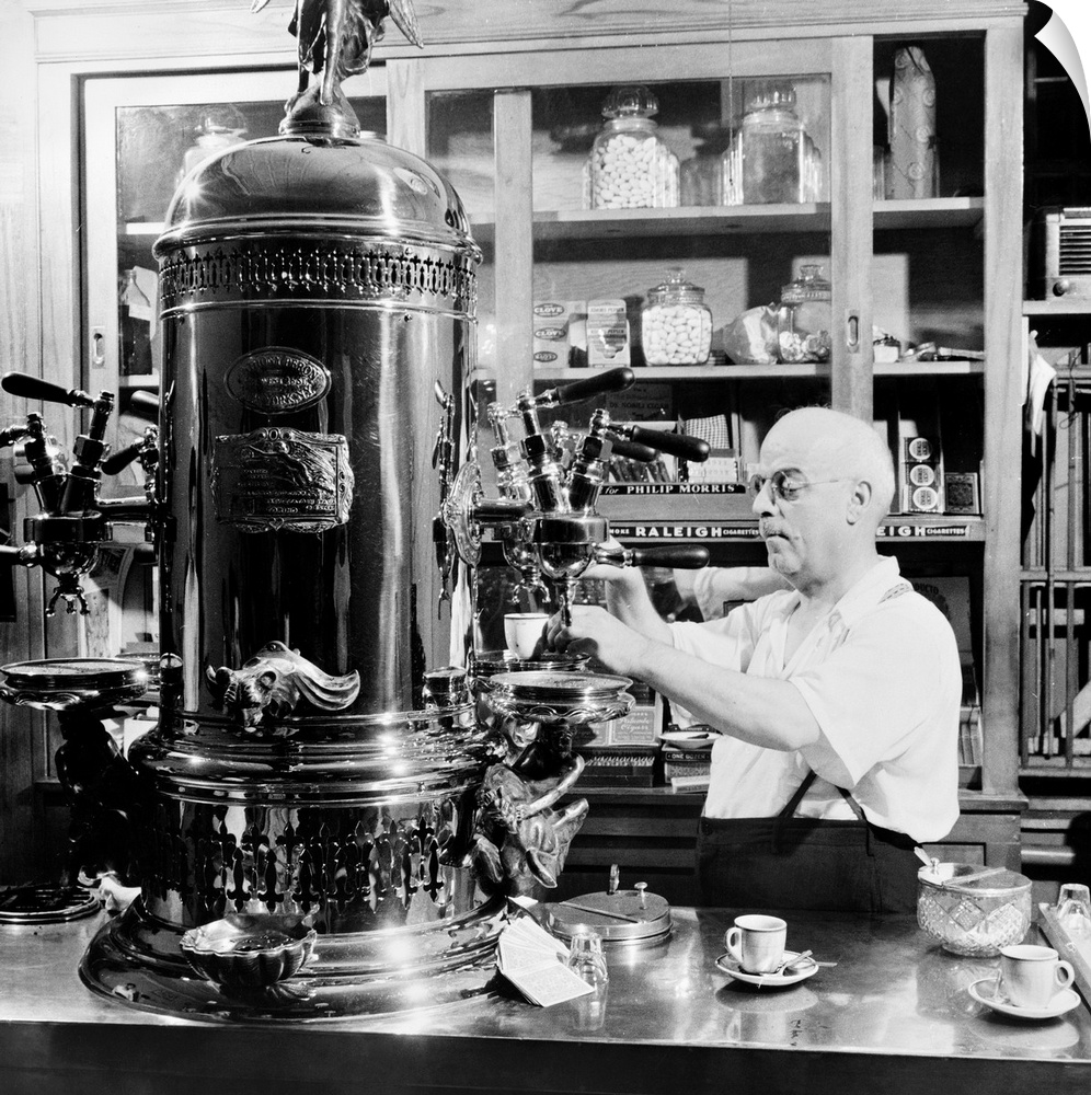 A man operating a cofee machine at an Italian-American caf? espresso shop on MacDougal Street in New York City. Photograph...