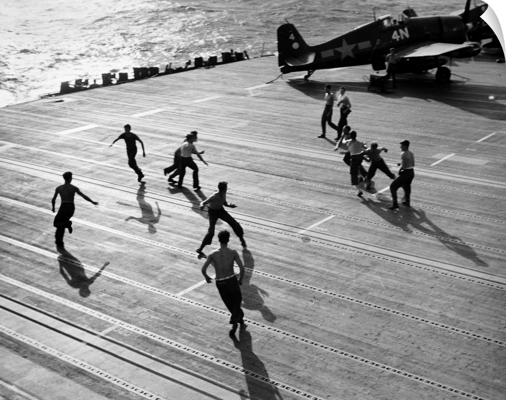 Crew members of the aircraft carrier USS Hornet, playing touch football on the flight deck, February 1945.