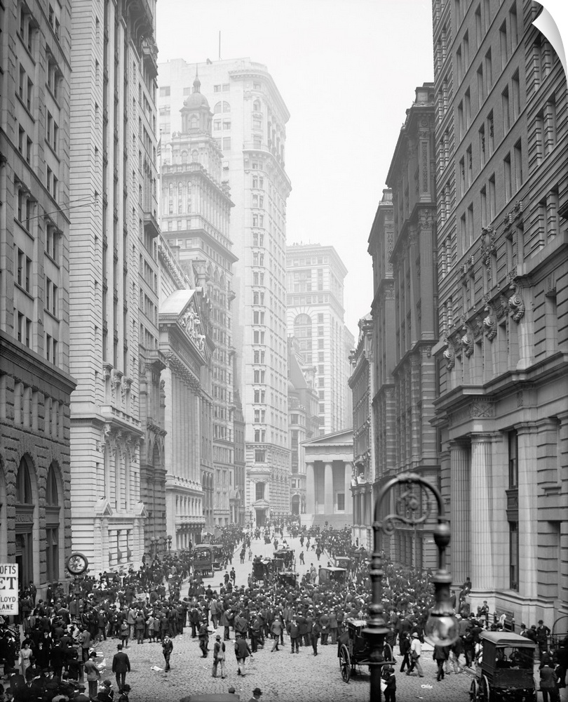 Crowd of men involved in curb exchange trading on Broad Street in New York City. Photograph, c1905.