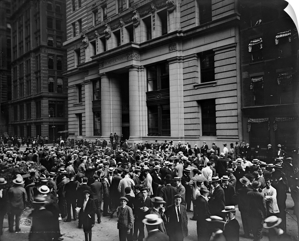 Crowd of men involved in curb exchange trading on Broad Street in New York City. Photograph, c1906.