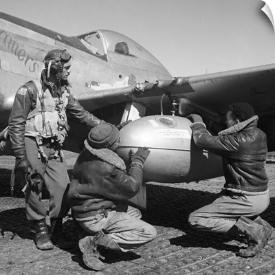 Edward Gleed and two other Tuskegee Airmen adjust an external 75 gallon drop tank, 1945