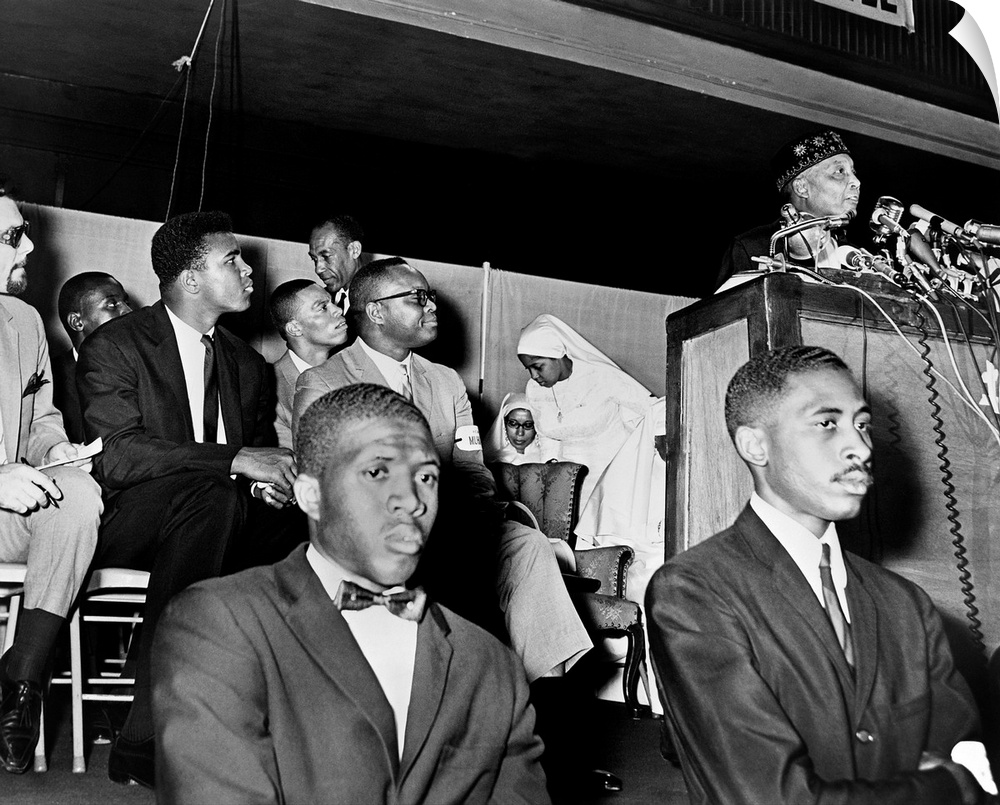 ELIJAH MUHAMMAD (1897-1975). African American leader of the Nation of Islam. Addressing followers, including Muhammad Ali ...
