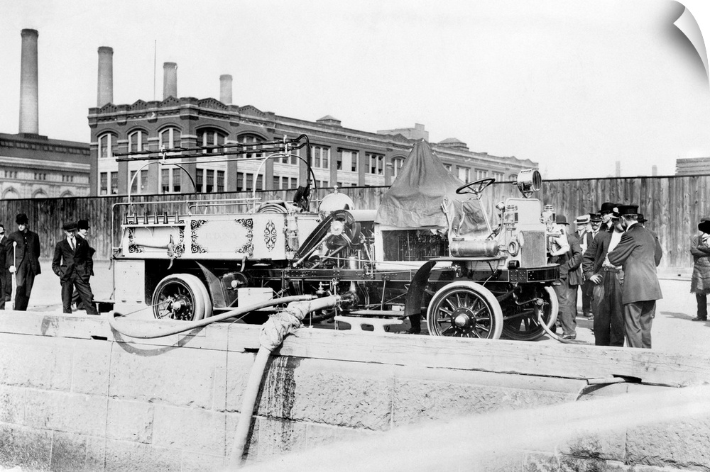 Fire engine of the Fire Department of New York being filled with water, c1911.