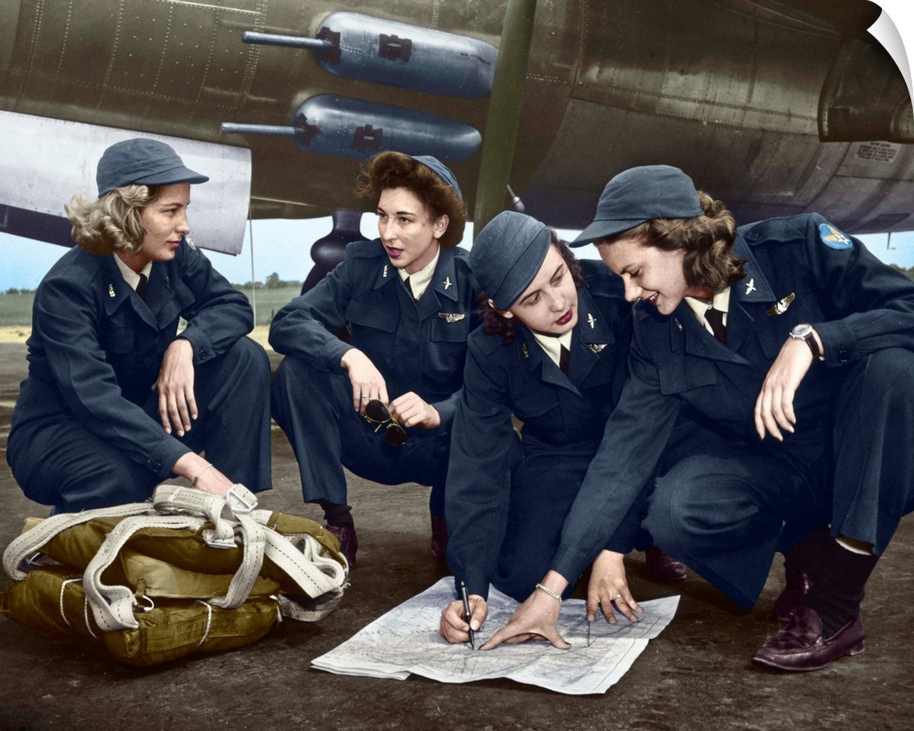 Four female pilots looking at a chart. Photograph, c1941, digitally colored by The Granger Collection.