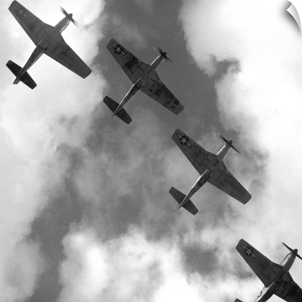 Four P-51 Mustang fighter planes flying in formation over Ramitelli, Italy. Photograph by Toni Frissell, March 1945