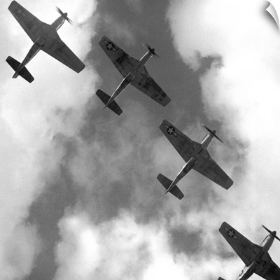 Four P-51 Mustang fighter planes flying in formation over Ramitelli, Italy, 1945