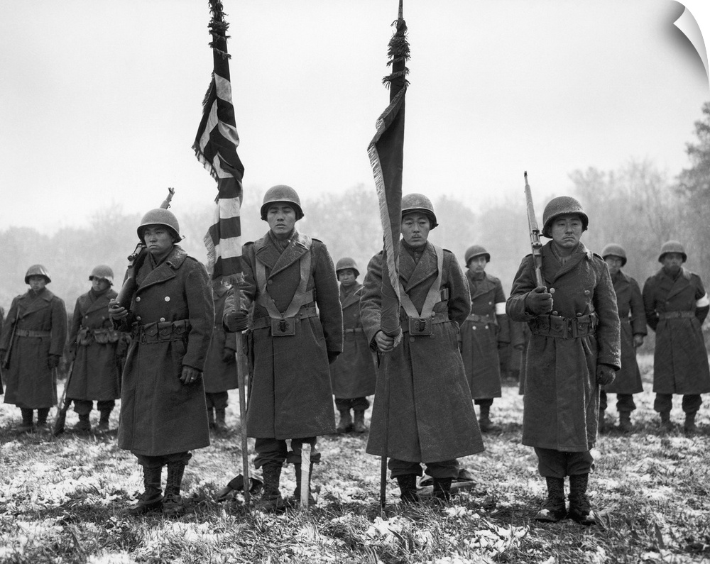 Color guards and color bearers of the Japanese-American 442nd Combat Team stand at attention at Bruyeres, France, on a bat...