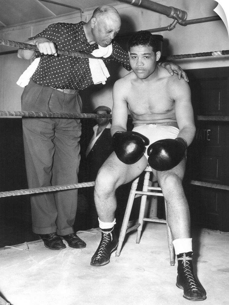 American heavyweight pugilist. In training camp at Pompton Lakes, New York, 4 June 1938, with his trainer Jack Blackburn.