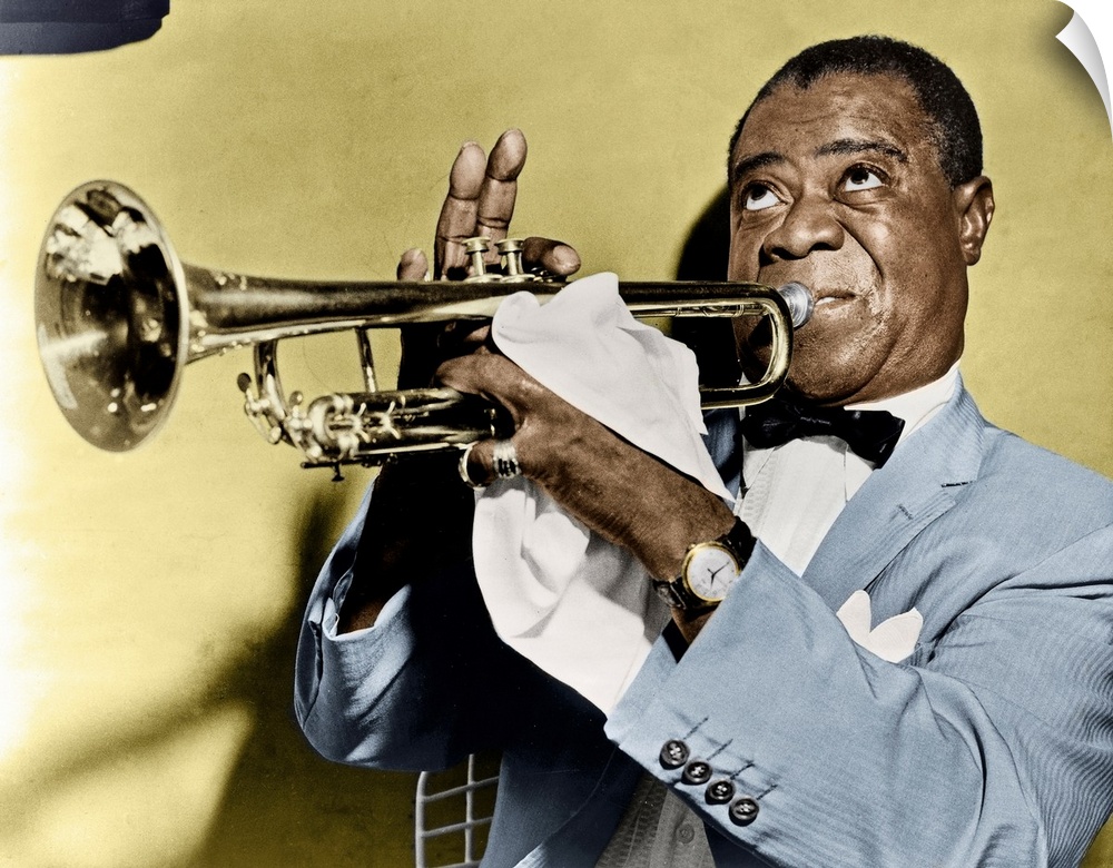 LOUIS ARMSTRONG (1900-1971). American jazz musician. Photographed playing trumpet, 1953.