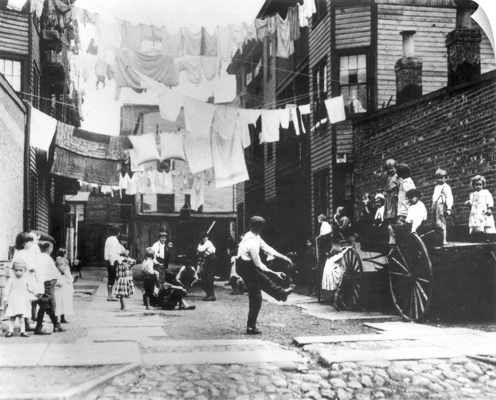 Children using a tenement alley for a playground in New York City. Photograph, c1910, by Lewis Hine.