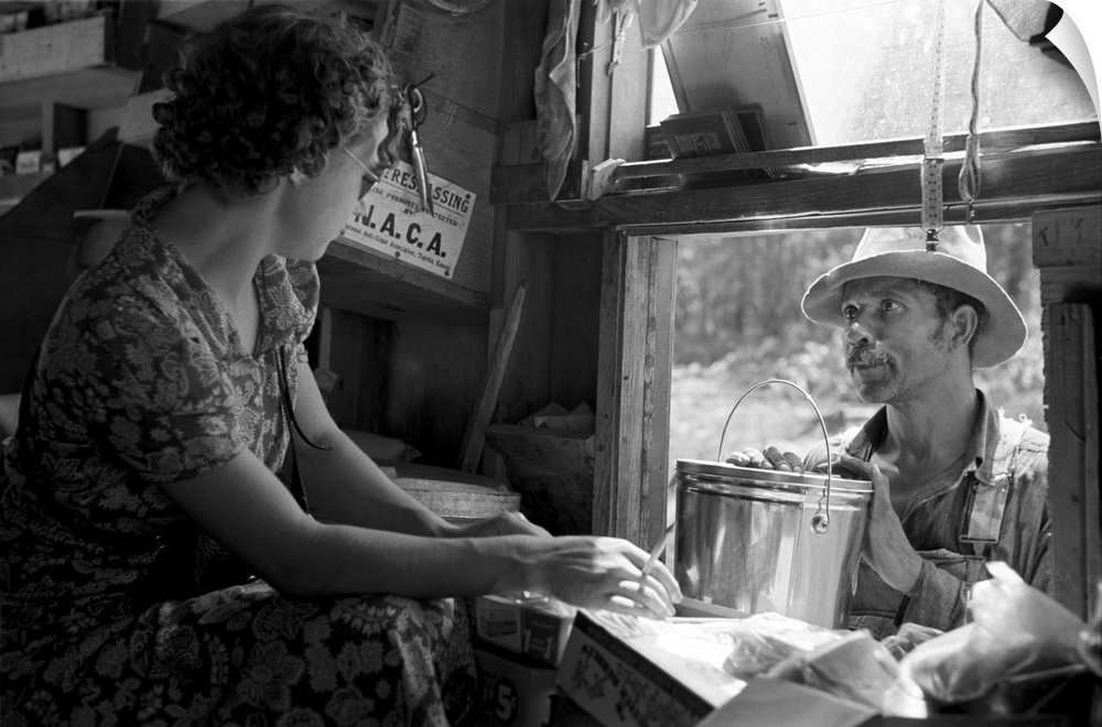 An African American sharecropper making a purchase from the traveling grocery store truck, Forrest City, Arkansas. Photogr...