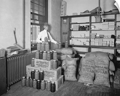 Prohibition, man displaying the utilization of confiscated bootlegger paraphernalia