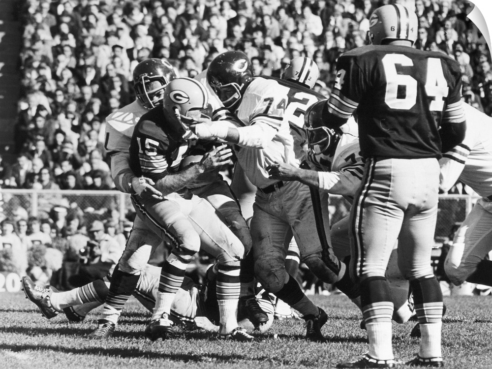 Quarterback Bart Starr of the Green Bay Packers being sacked for an 11-yard loss by Dick Butkus and Bob Kilcullen (74) of ...