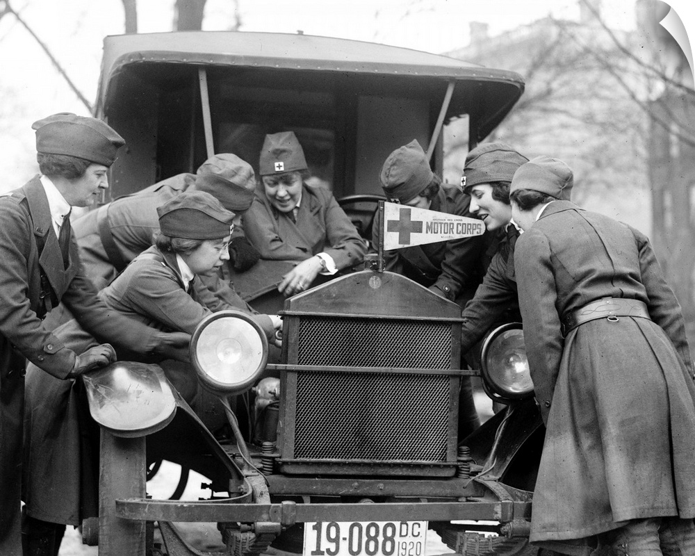 Members of the American Red Cross Motor Corps learning to fix an automobile engine, c1920.