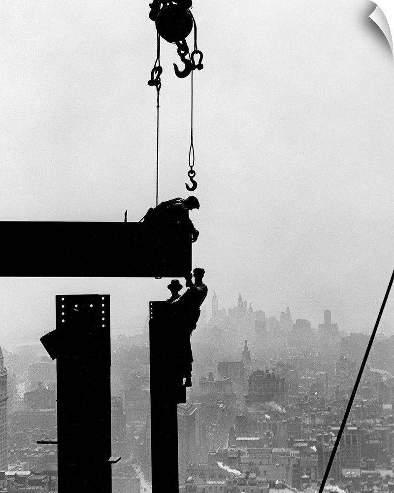 Steel workers on girders at the Empire State Building in New York City. Photograph by Lewis Hine, c1930.