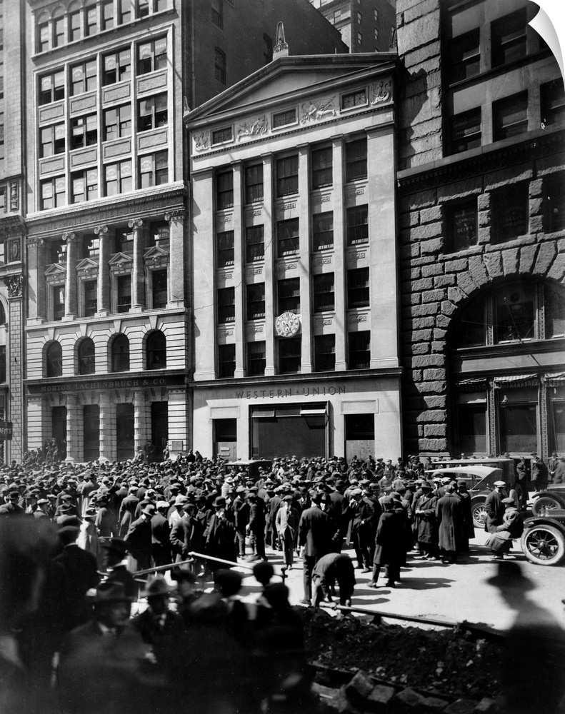 Crowd of men involved in curb exchange trading in front of the Western Union Building, New York City. Photograph by Irving...