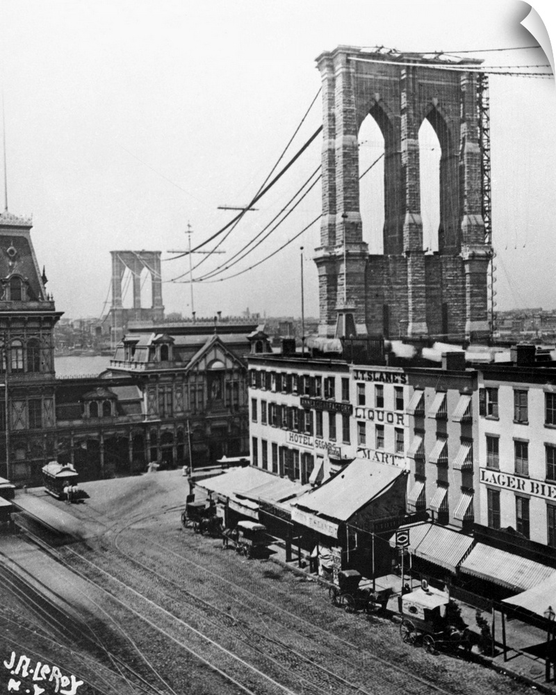 View from Brooklyn of the Brooklyn Bridge under construction over the East River in New York City, c1880.