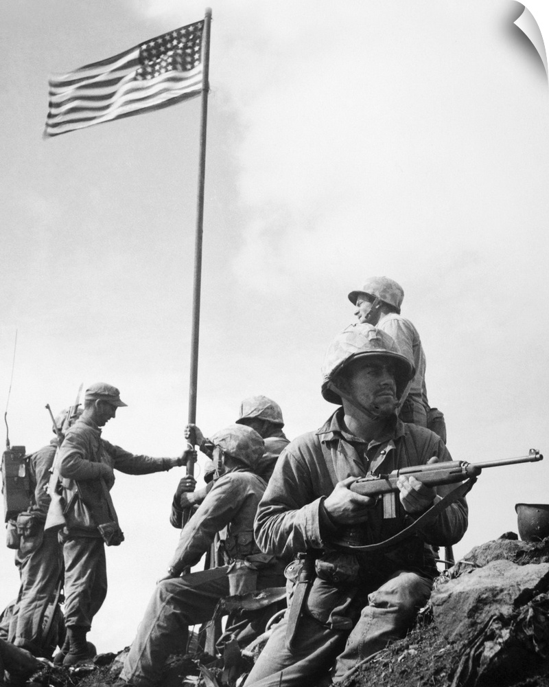 The raising of the first flag on Mount Suribachi, Iwo Jima, 23 February 1945. The soldiers are Sergeant Henry Hansen (with...