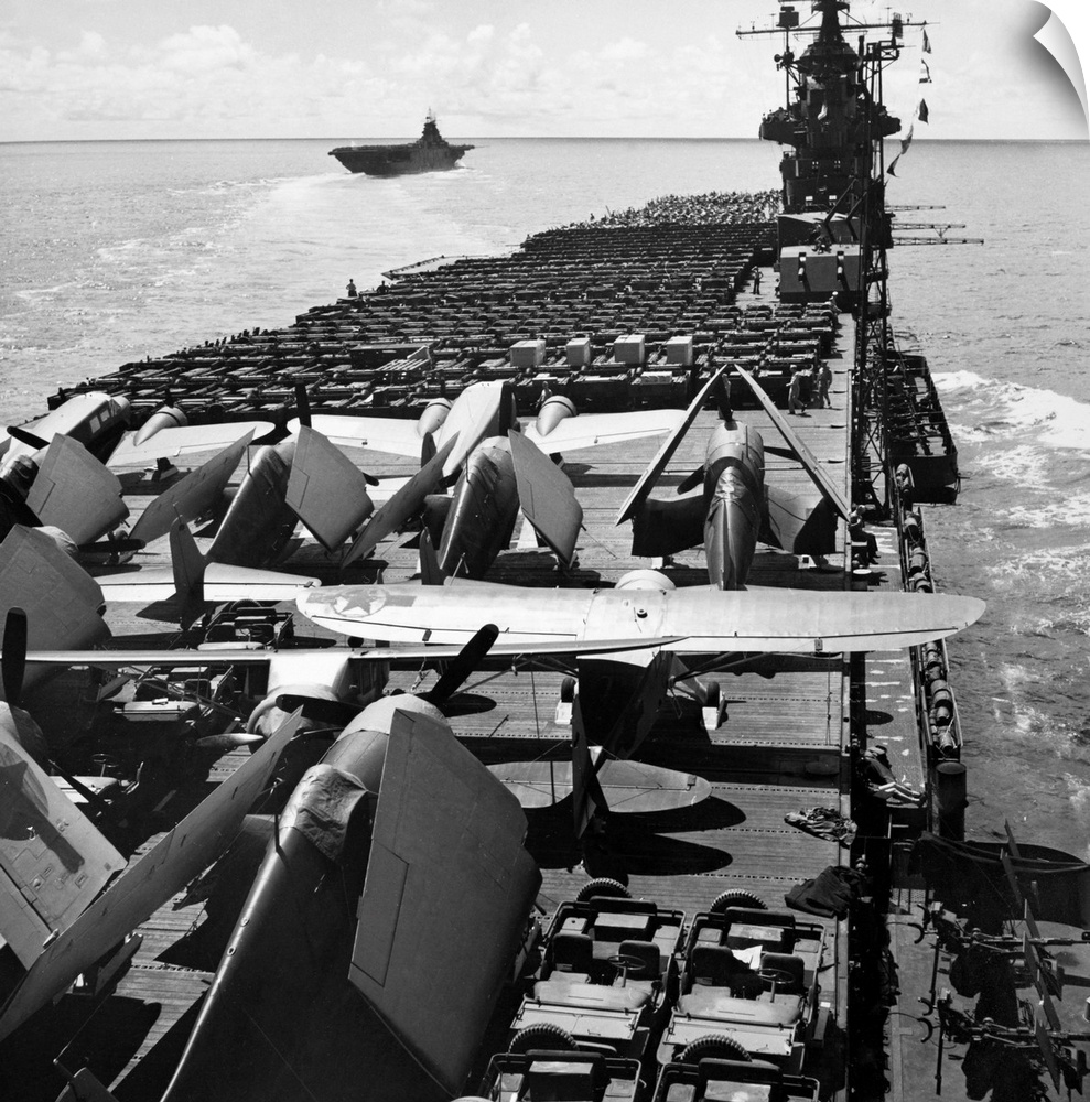 The USS Yorktown aircraft carrier ferries planes and jeeps to battle fronts in the Pacific. Photograph, September 1943.