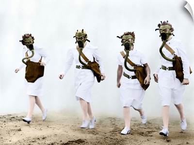 U.S. Army nurses advance through a cloud of smoke in a gas mask drill during training