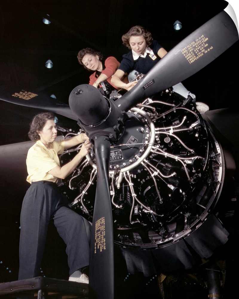 Women installing an aircraft engine at the Douglas Aircraft plant in Long Beach, California. Photograph by Alfred T. Palme...