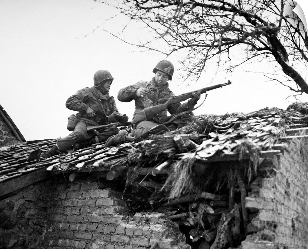 American rifleman on a rooftop in Beffe, Belgium, snipe German snipers. Photographed 7 January 1945.