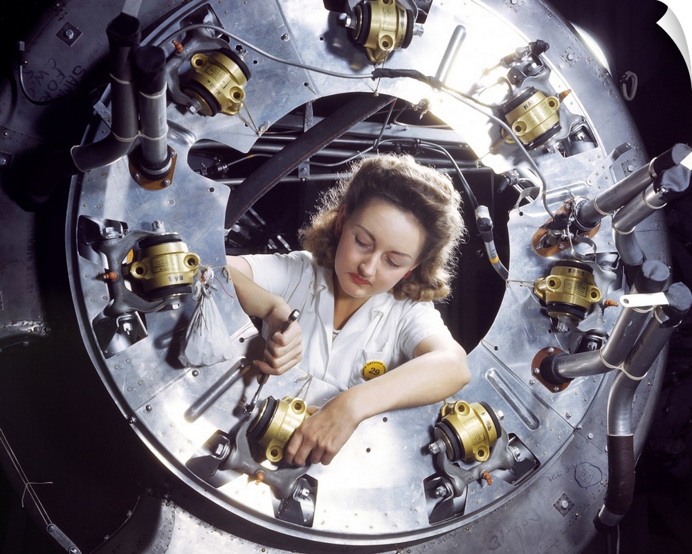 A woman working on a motor for a B-25 bomber at the North American Aviation plant in Inglewood, California. Photograph by ...