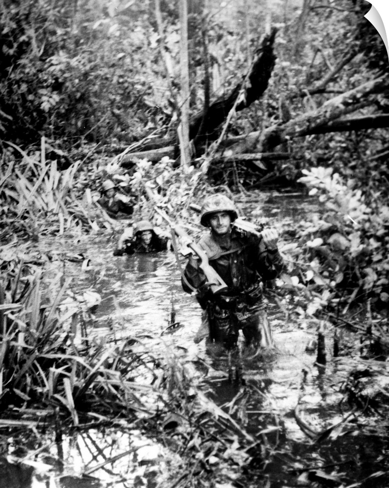 U.S. Marines advancing through the jungle of Cape Gloucester, on the island of New Britain, New Guinea, 18 January 1944.