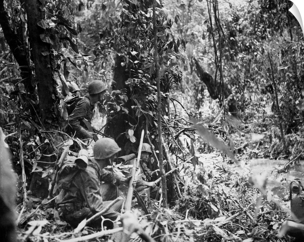 U.S. Marines wait for a tank to advance during the drive to capture the Japanese airstrip at Cape Gloucester, island of Ne...
