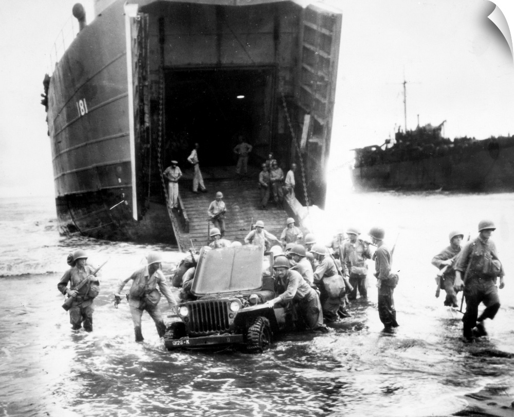 A stalled jeep is pushed ashore by U.S. infantrymen during the invasion of Wake Island, Dutch New Guinea, during World War...