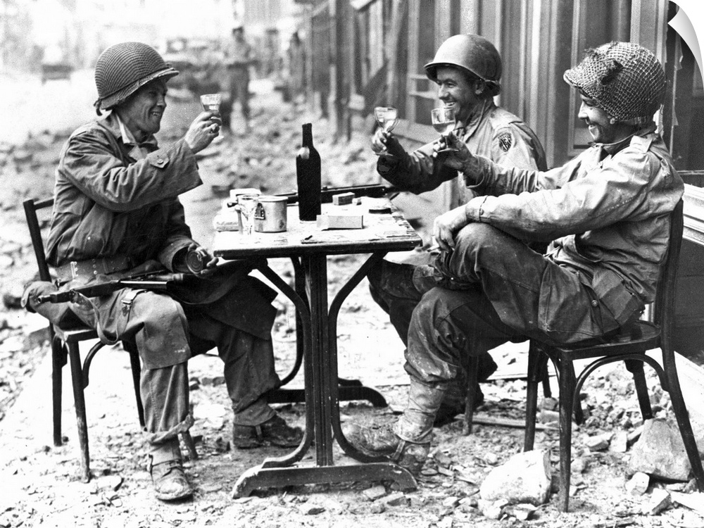 Three American soldiers at a sidewalk cafe in Paris, France, following the Allied liberation of the city, August 1944.