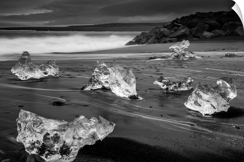 Fragments of ice on the dark sand on the Icelandic coast.