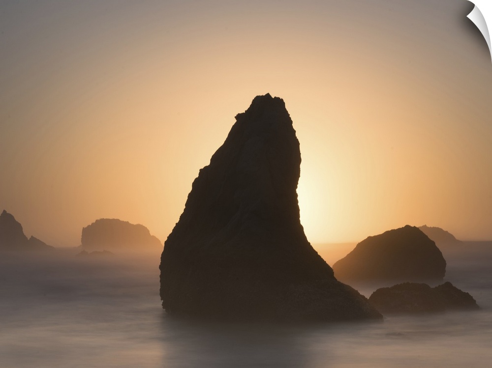 Pointed sea stack in the misty ocean in the morning, Bandon, Oregon.