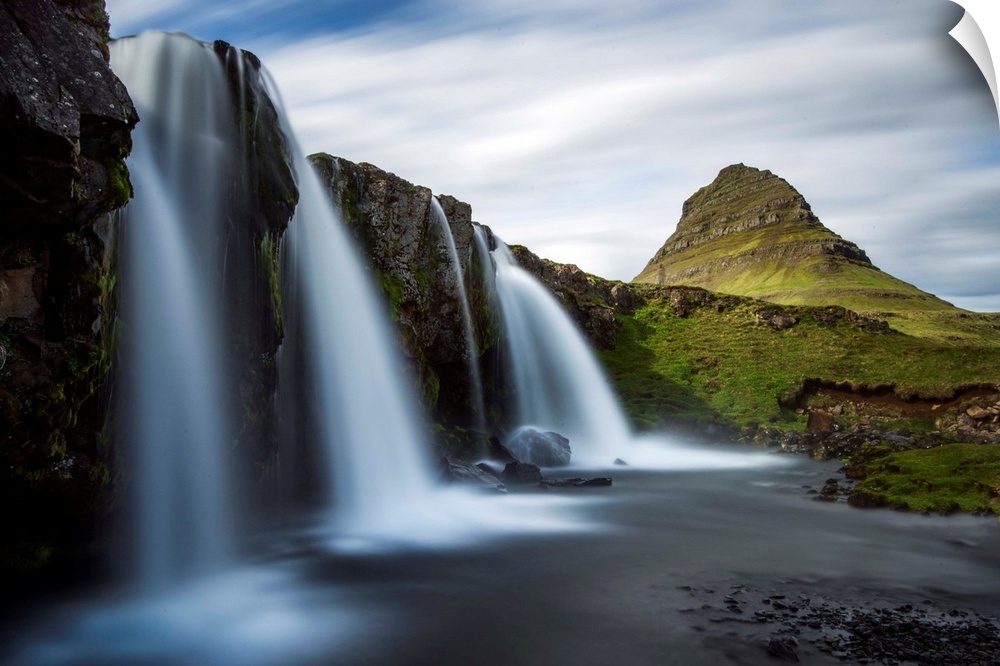 Waterfalls in Iceland with verdant Mount Kirkjufell in the distance.