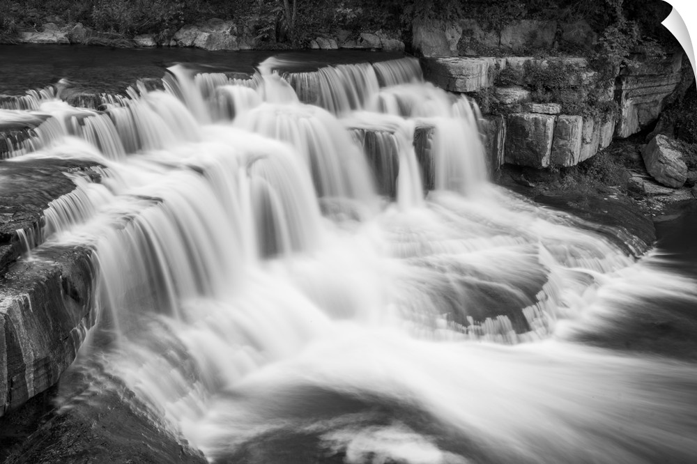 Black and white image of a rushing waterfall in Ithaca, New York.