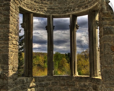 A bay window set in stoone walls overlooking the countryside