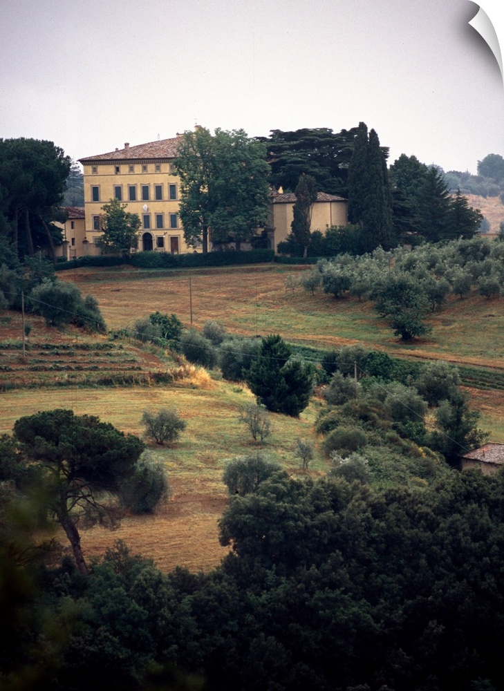 A large estate sits on top of a hill in the countryside of Tuscany, Italy