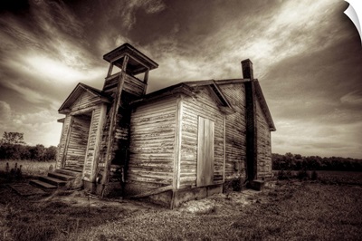 A timber shack with dramatic sky