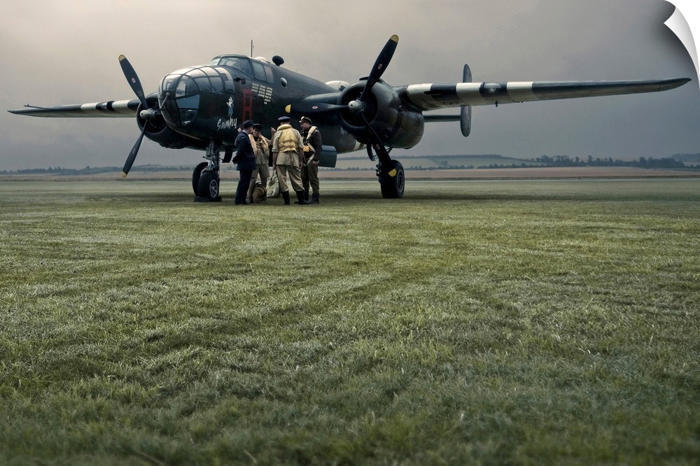 A B-25 Mitchell bomber and crew at dawn