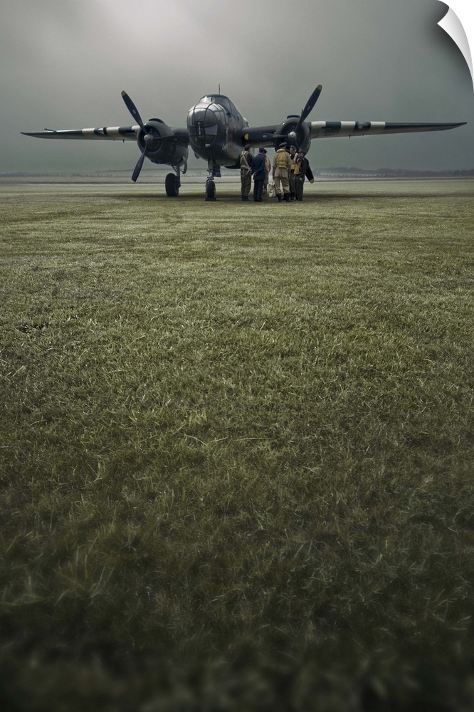 A B-25 Mitchell bomber and crew at dawn in portrait.